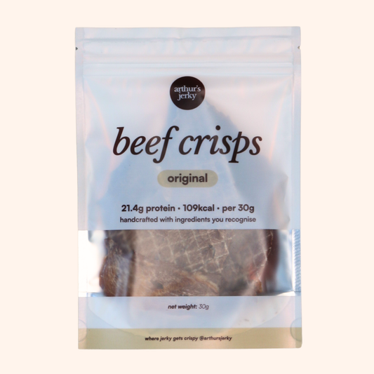 Package of Arthur's Jerky beef crisps on a beige background; 21.4g protein, 109kcal